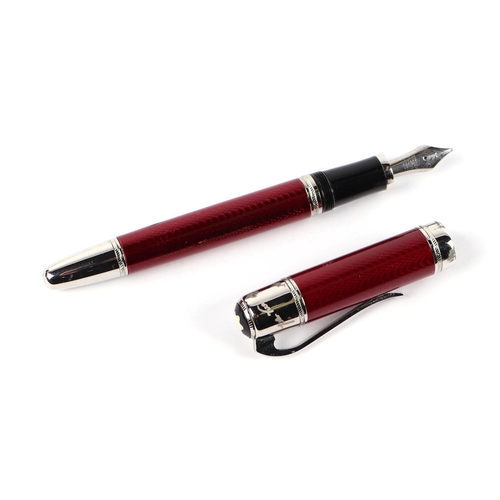 1034 - A red guilloche enamel fountain pen with iridium point nib, 15cms long.