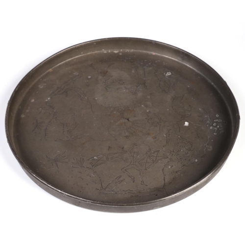 1042 - A Swedish Svenskt Tenn circular pewter tray, with folk art wriggle work decoration depicting figures... 