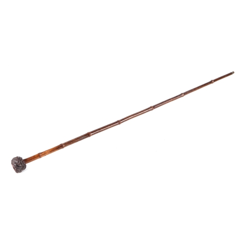 108 - A German pre 1947 bamboo sword stick, the pommel with a Nazi party enamel badge, 86cm long.