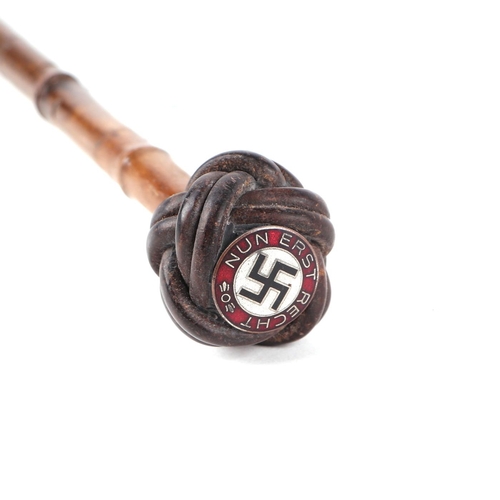 108 - A German pre 1947 bamboo sword stick, the pommel with a Nazi party enamel badge, 86cm long.