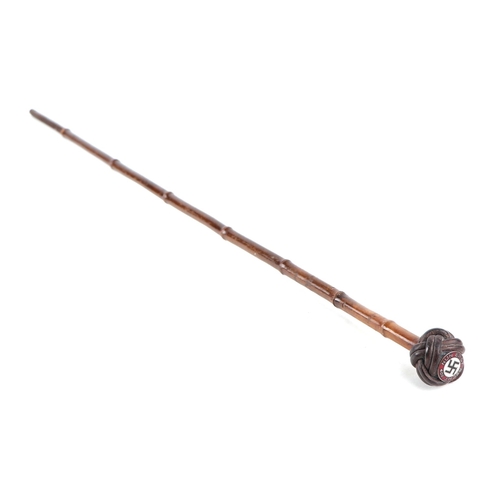 108 - A German pre 1947 bamboo sword stick, the pommel with a Nazi party enamel badge, 86cm long.