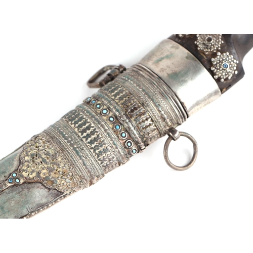 110A - A Persian Khanjar dagger with steel double fuller curved blade, jewelled with metal scabbard and hor... 