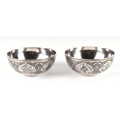 1133 - A pair of Persian silver bowls with fine hand engraved traditional decoration, 11.5cms diameter, 256... 