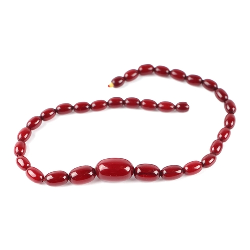 1216 - A graduated sting of cherry amber Bakelite beads with marbling to the beads, the largest bead 2.5cms... 