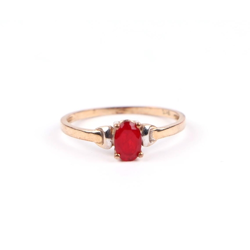 1223 - A 9ct gold dress ring set with an oval red stone (possibly synthetic ruby), approx UK size 'K', 0.9g... 