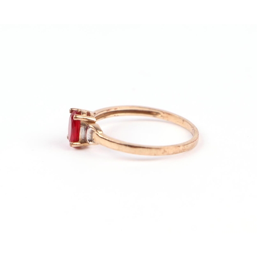 1223 - A 9ct gold dress ring set with an oval red stone (possibly synthetic ruby), approx UK size 'K', 0.9g... 