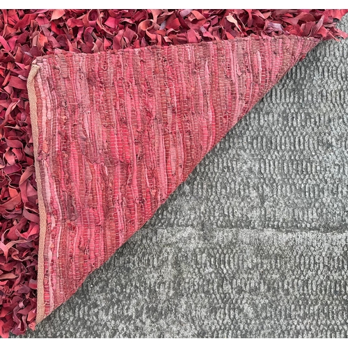 1365 - A modern design leather strip shag rug, 230 by 170cms.