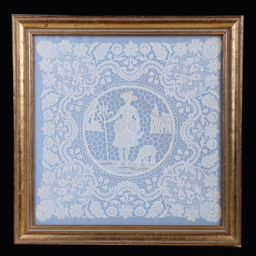 1369 - A 19th century lacework panel with central roundel depicting a girl with a lamb with buildings in th... 