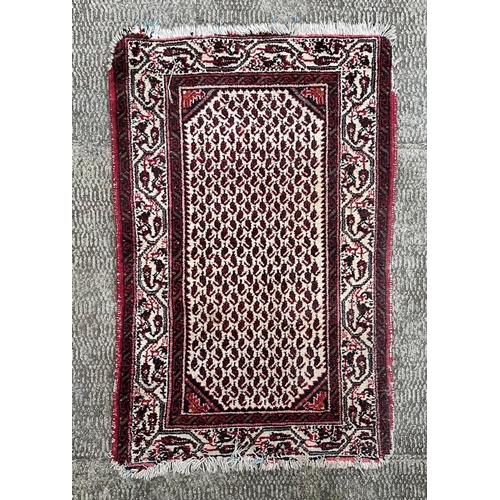 1370 - A Caucasian prayer rug, having a central floral repeating motif within a multi border, 115cm by 75cm... 