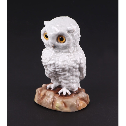 1400 - A Victorian pottery figure of a snowy owl with glass eyes, 16cms high.