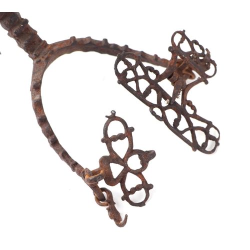 1454 - A pair of 17th century steel Rowel spurs of ornate design, probably English, 16cms long.