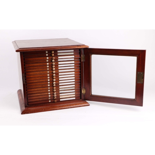 1492 - A late 19th/early 20th Century mahogany microscope slide cabinet, the single glazed door enclosing t... 