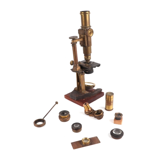 1493 - A Victorian monocular brass microscope with accessories, boxed.