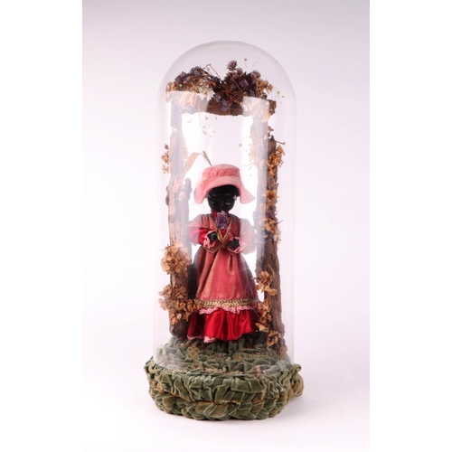 1564 - A Victorian style automaton black doll in Victorian dress standing beneath a floral arch, under a gl... 