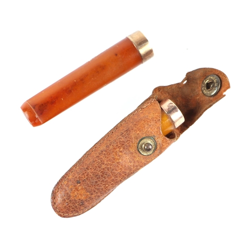 1568 - A 9ct gold mounted amber cheroot holder in a leather pouch together with a similar larger.(2)