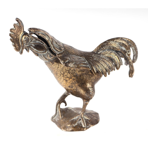 1571 - A cast gilt brass table top trinket box in the form of a crowing cockerel standing on a rock, approx... 