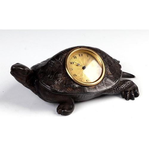 1682 - A patinated metal table clock in the form of a tortoise the gilt dial with Arabic numerals, 17cm lon... 