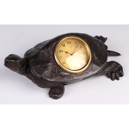 1682 - A patinated metal table clock in the form of a tortoise the gilt dial with Arabic numerals, 17cm lon... 