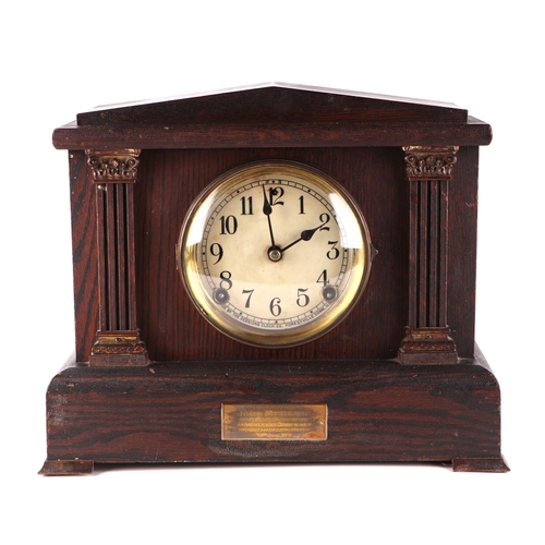 1690 - An Edwardian architectural oak mantle clock, having a white dial with arabic numerals fitted a eight... 