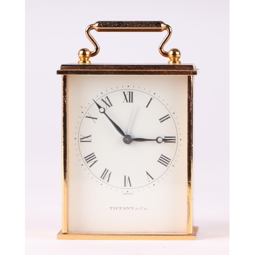 1691 - A Tiffany and Co brass cased mechanical alarm clock with fifteen jewel movement, the white dial with... 