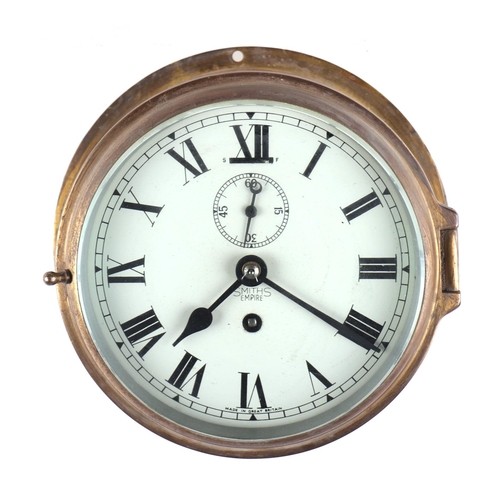 1693 - A brass cased Smiths Empire bulkhead clock, the white dial with Roman numerals and subsidiary second... 