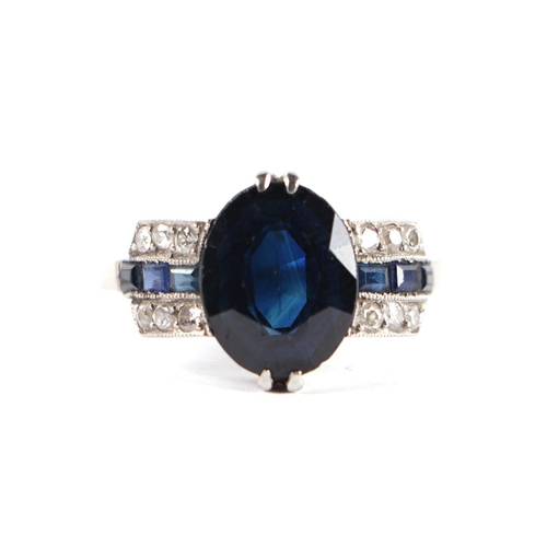 1823 - A French Art Deco platinum, sapphire and diamond ring with calibre cut sapphires to the shoulders, a... 