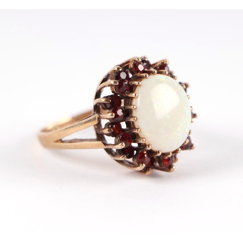 1824 - A 9ct gold opal and garnet cluster ring with central opal surrounded by a halo of garnets, approx UK... 