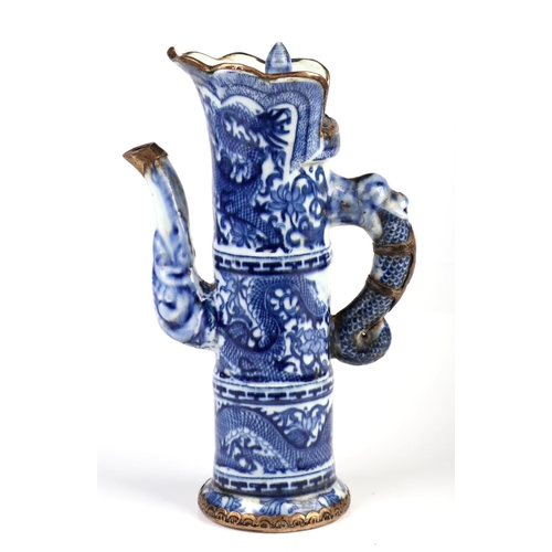 1956 - A Chinese blue and white ewer of cylindrical form decorated dragons with blue seal mark to the under... 