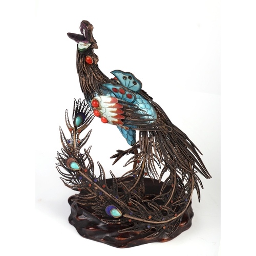 1959 - A Chinese gilt white metal and enamel figure of a peacock on a hardwood stand, overall 16cm high