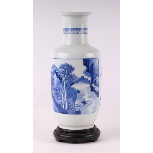 1971 - A Chinese blue and white rouleau vase decorated with a river landscape and precious objects, on a ha... 