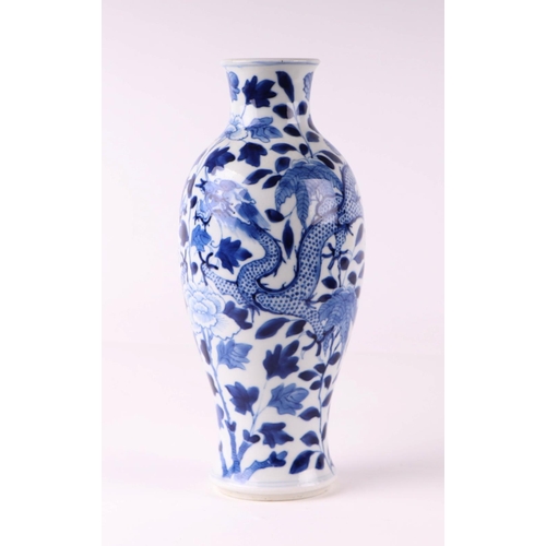 1976 - A Chinese blue and white vase decorated with dragons chasing a flaming pearl amongst foliage, 23.5cm... 