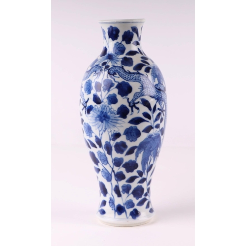 1976 - A Chinese blue and white vase decorated with dragons chasing a flaming pearl amongst foliage, 23.5cm... 