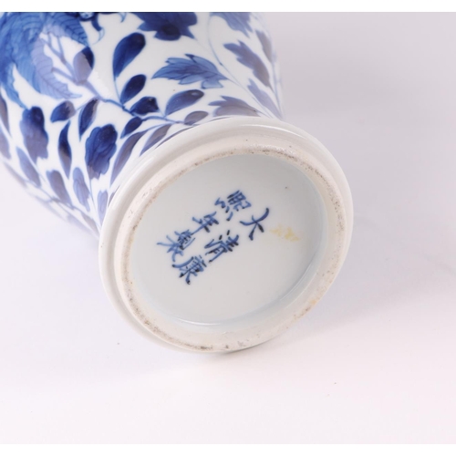 1976 - A Chinese blue and white vase decorated with dragons chasing a flaming pearl amongst foliage, 23.5cm... 