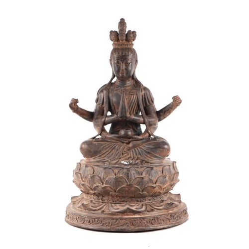 1980 - A large patinated metal multi-armed deity seated on a lotus flower, 38cms high.