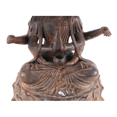 1980 - A large patinated metal multi-armed deity seated on a lotus flower, 38cms high.