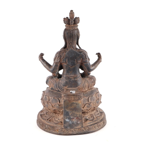 1980 - A large patinated metal multi-armed deity seated on a lotus flower, 38cms high.