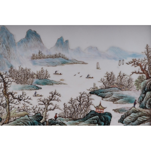 1989 - A Chinese rectangular porcelain plaque depicting a river landscape scene, framed, 42 by 26cms.