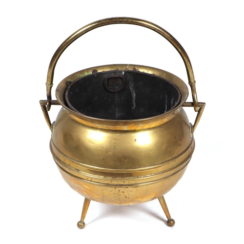 1990 - An Arts & Crafts brass cauldron shaped tripod coal bucket by William Soutter & Sons Co., 35cms high.