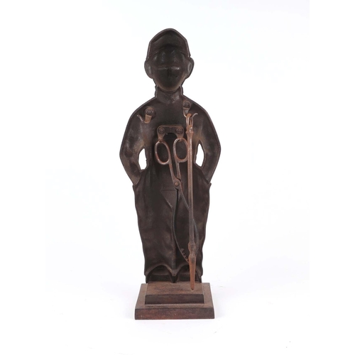 1991 - A cast iron Dutch Boy fireside companion, stamped 'Nestor, Made in England' 52cm high.