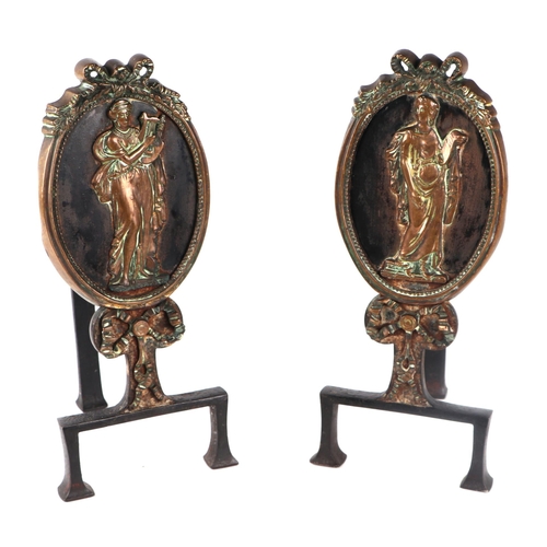 1991A - A pair of 19th century iron and brass andirons decorated with panels depicting neo-classical figures... 