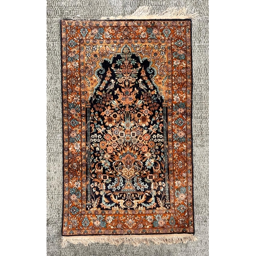 1996 - A small silk Kashan rug with central medallion and foliate decoration, on a blue and russet ground, ... 