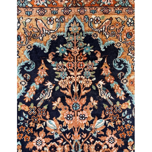 1996 - A small silk Kashan rug with central medallion and foliate decoration, on a blue and russet ground, ... 