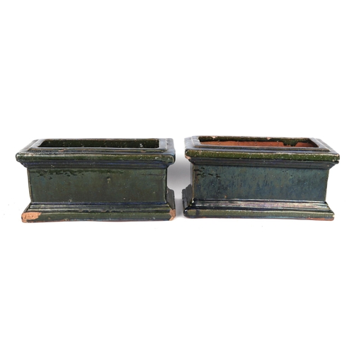 2 - A pair of green glazed terracotta planters, each 34cm wide, (2)