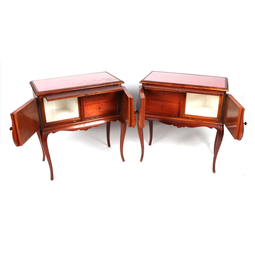 2014 - A pair of French bedside cabinets, possibly fruitwood, the rectangular top above a brushing slide wi... 