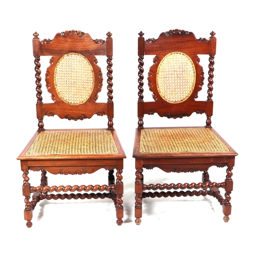 2062 - A pair of 17th century style walnut hall chairs with cane work back and seats, on barleytwist suppor... 