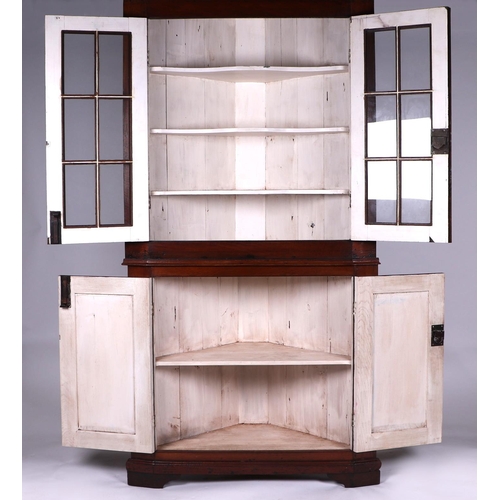 2063 - A 19th century oak corner glazed display cabinet on cupboard, the moulded cornice above twin paned g... 