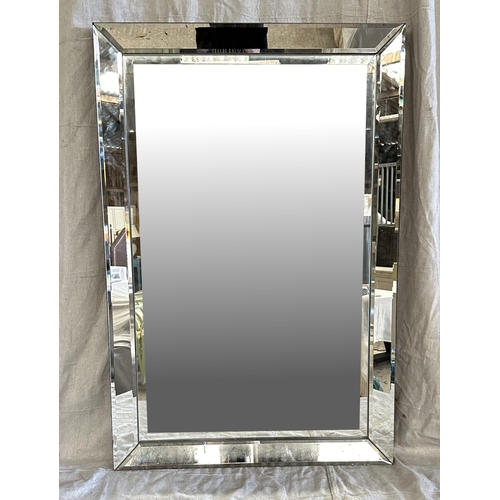 2081 - A Lune wall mirror, 61 by 92cms.