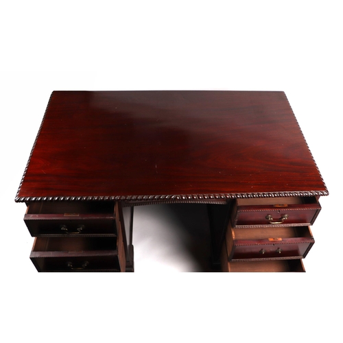 2083 - A George III style mahogany kneehole pedestal desk, the rectangular top with carved rope twist edge,... 