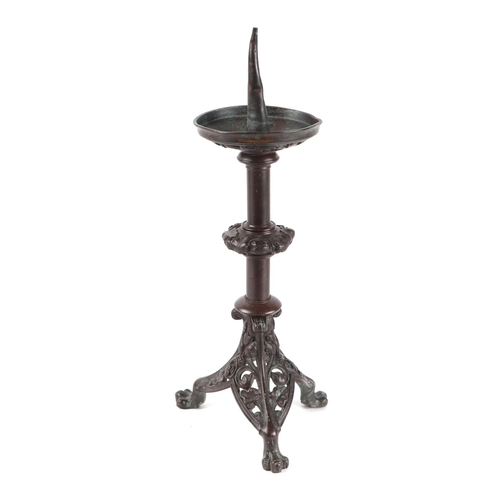 224 - A bronze pricket candlestick on pierced tripod base, 38cms high.