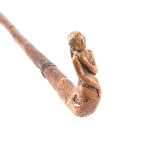 255 - A treen walking stick, the handle carved in the form of a mermaid, 82cms long; together with a surve... 